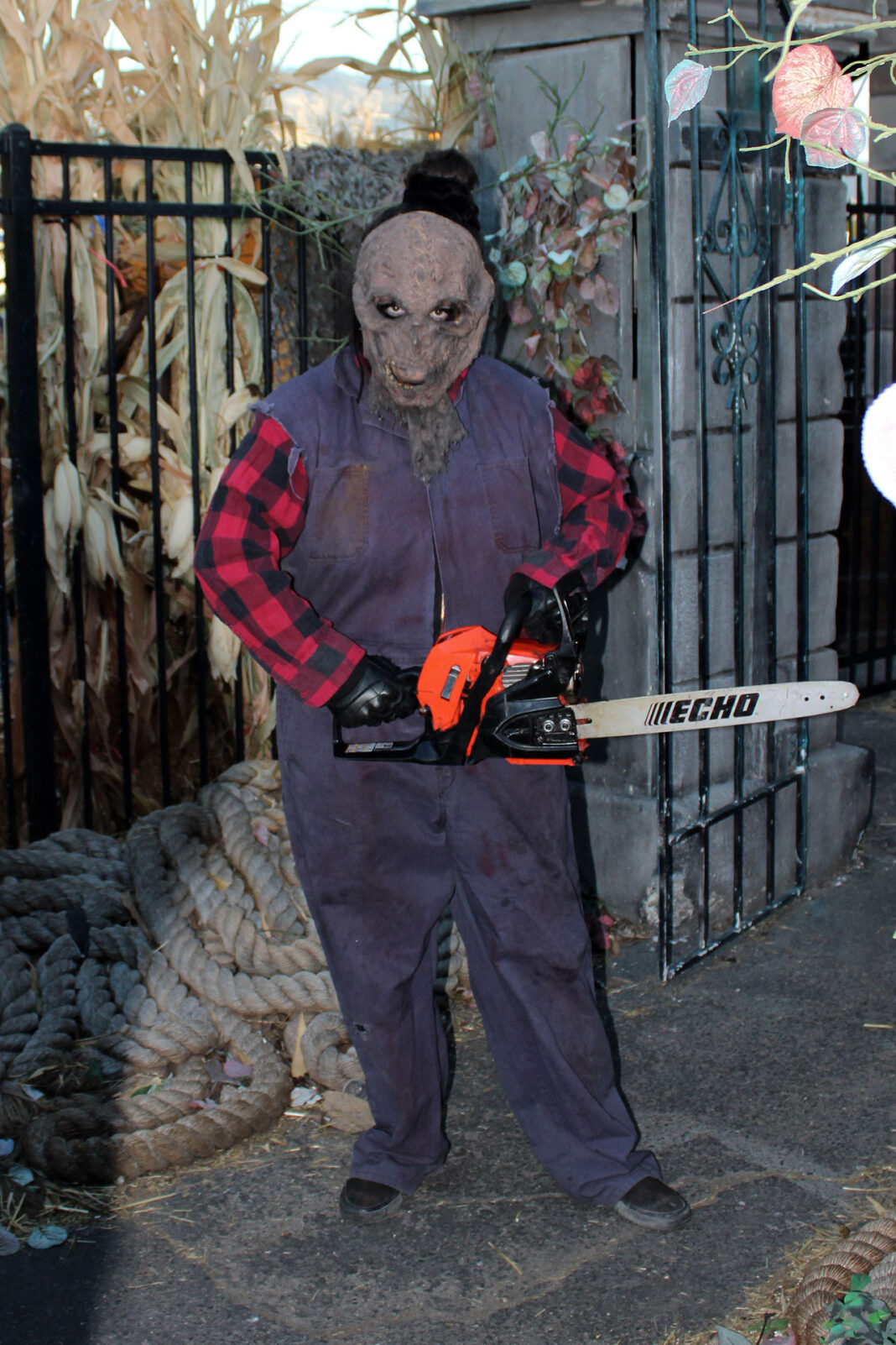 Maniacal scarecrow revving a chainsaw