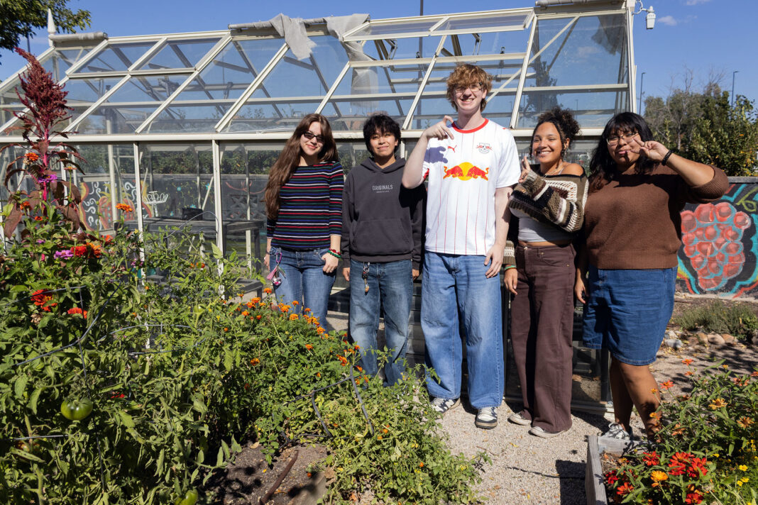 Five students standing together in the garden area