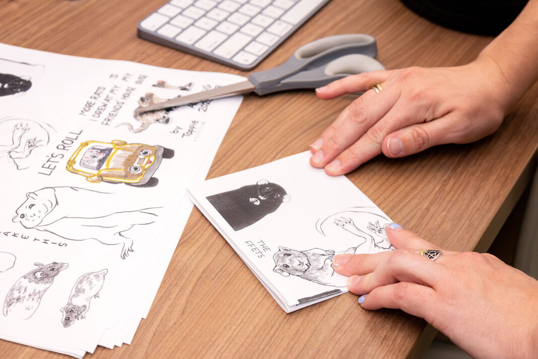 Landscape photo of Oliver Harrington making more zines for the Zine Machine