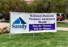 Opinion: Enough is enough. It’s time to break the silence and shine a light on domestic violence Large banner on a Sandy City lawn announcing National Domestic Violence Awareness Month - "Stop the Violence, End the Silence"