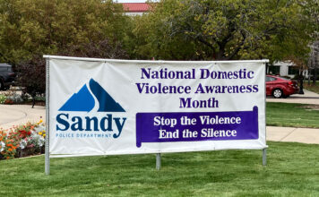 Opinion: Enough is enough. It’s time to break the silence and shine a light on domestic violence Large banner on a Sandy City lawn announcing National Domestic Violence Awareness Month - "Stop the Violence, End the Silence"