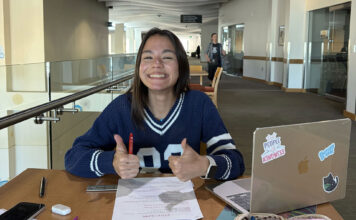 Students at SLCC confront procrastination as deadlines pile up Stephanie smiling and giving two thumbs up while studying