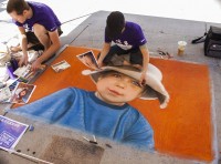 Trent Tripp, left, and Melody Tripp drawing chalk art