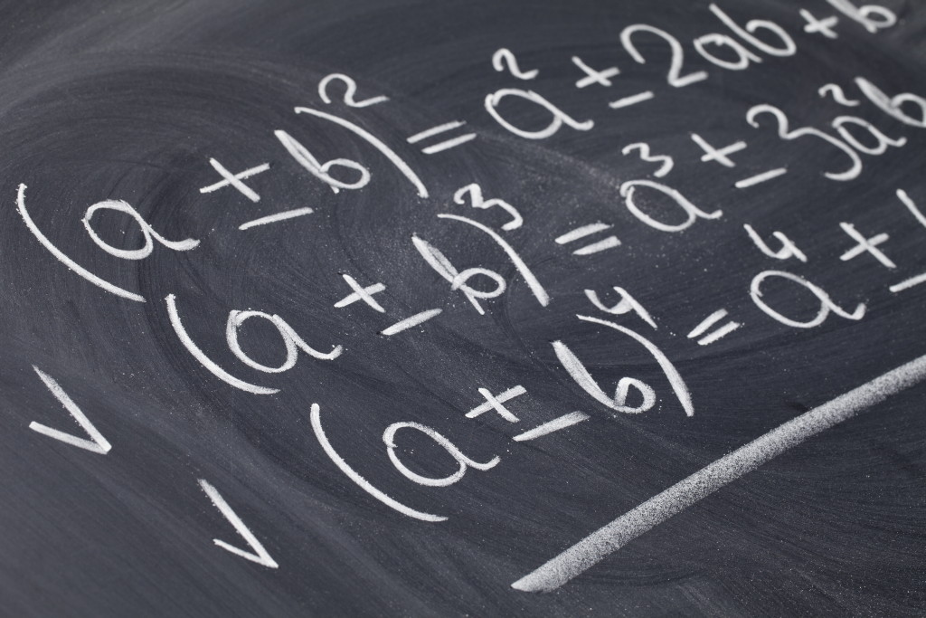 Make sure your classes add up to graduation Three algebra equations written on a chalkboard
