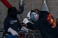 Shadia Trussel and Brandon J. Ward practicing welding