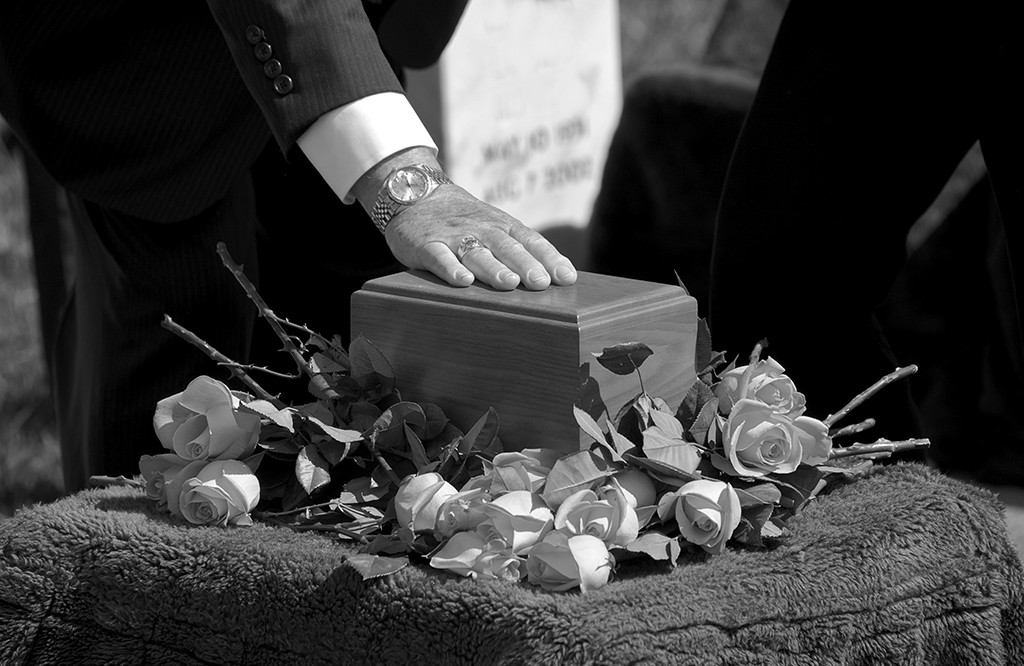Students learn to take care of the dead through SLCC mortuary science program Box of ashes on top of roses at a cemetery