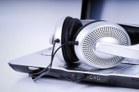 Jam out with Radio SLCC Headphones plugged into a laptop