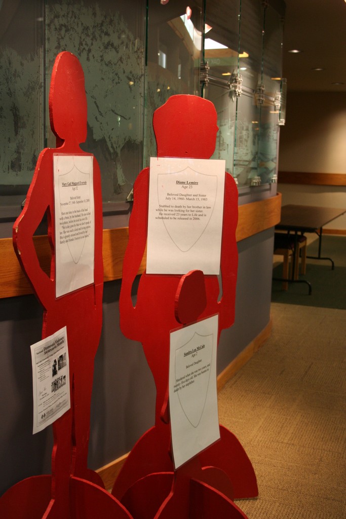 Where to get help against domestic violence Red silhouettes represent victims of domestic violence.