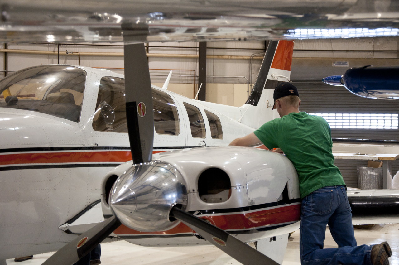 Aviation program constrained by space limits Aviation student works on an airplane