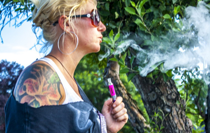 Vaping causes controversy at Salt Lake Community College Woman smoking e-Cigarette
