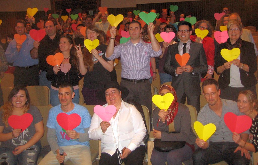 TED talk presenter connects people through images Ronny Edry (with microphone) leads SLCC members in a photo for peace
