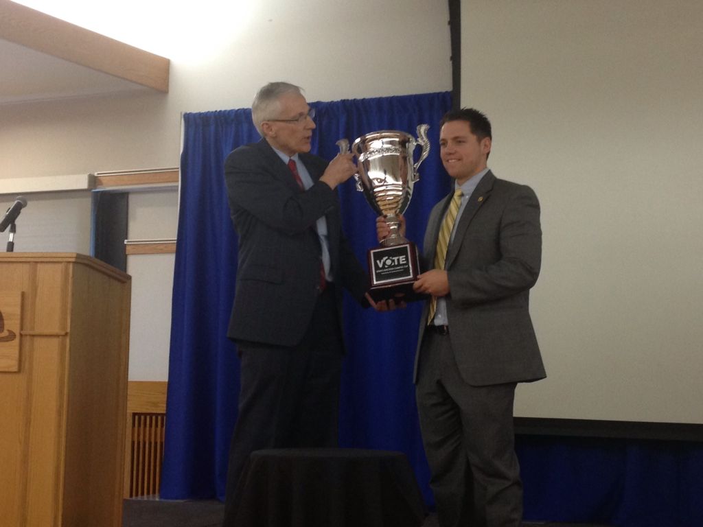 Election Campus Cup awarded to SLCC Lieutenant Governor Greg Bell (left) presents SLCC student council president Aaron Starks (right) with Utah's Election Campus Cup.