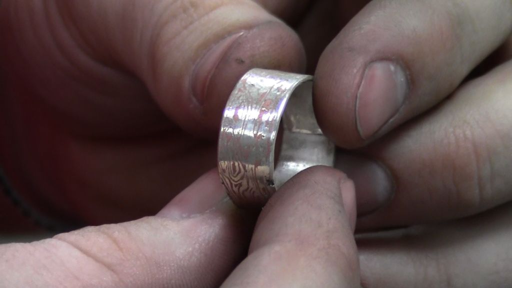 Love rings true for student in jewelry class Showing the grain of the metal of his wedding band.