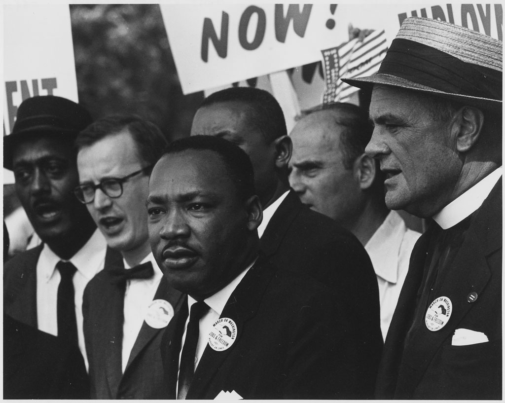 From Inside the Glass: Martin Luther King Jr. Day helps us remember Dr. Martin Luther King surrounded by supporters